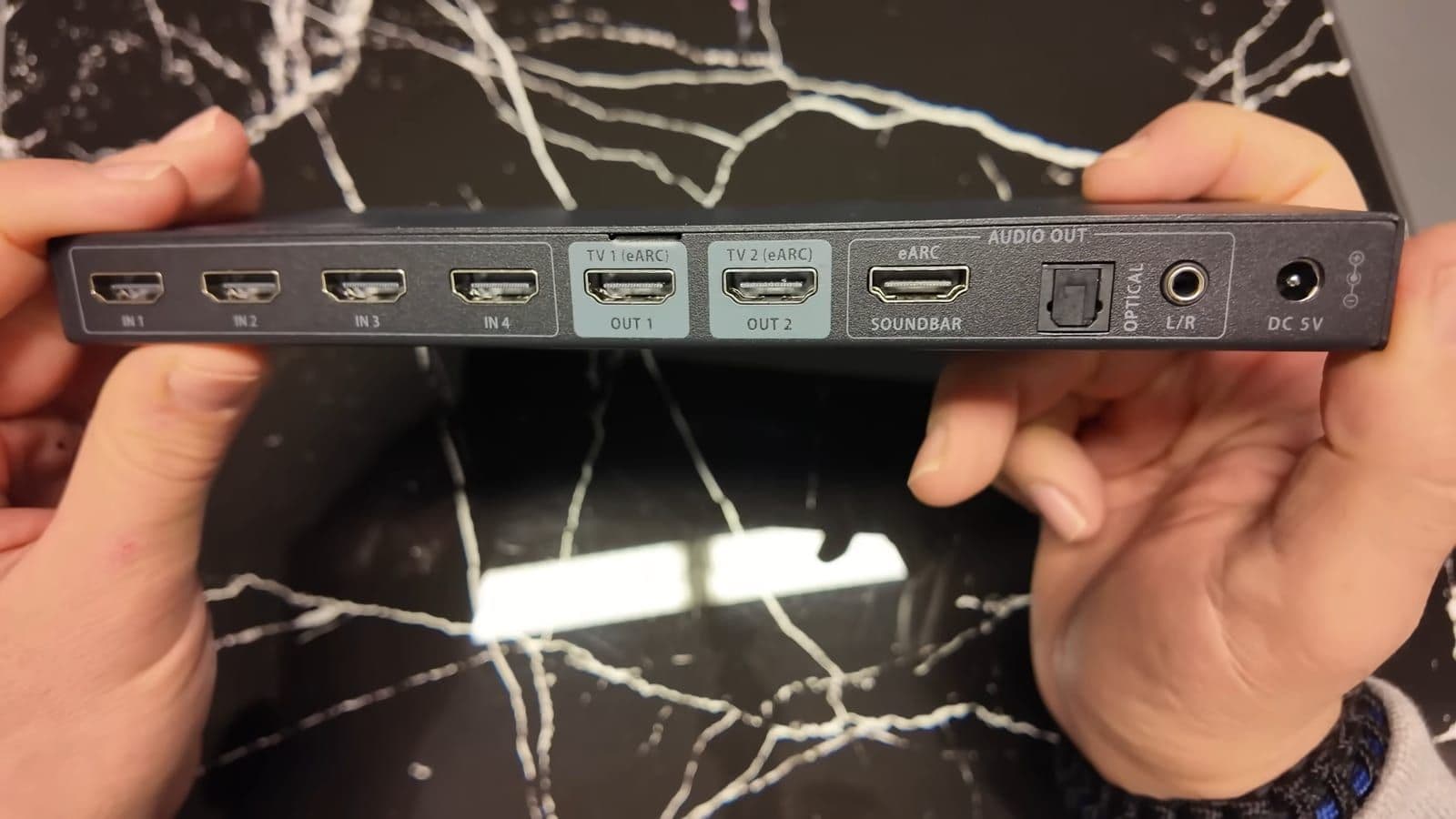Close-up of the rear HDMI ports, Toslink optical out, and 3.5mm AUX jack