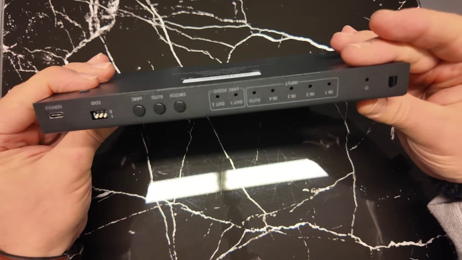 Close-up of the front panel switch buttons, EDID toggle, and USB-C service port